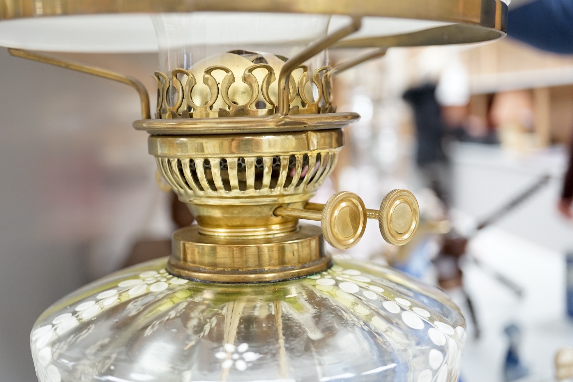 A late 19th century brass oil lamp with painted bowl and opaque shade together with a later oil lamp, largest 59cm high. Condition - fair to good